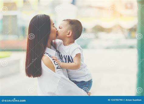 Mom and Son Kissing at Room